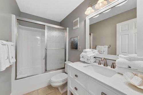 ein Bad mit einem WC, einem Waschbecken und einer Dusche in der Unterkunft The Breakers 61 in Orange Beach