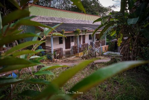 a small white house with a green roof at Hill Station Hostel at Chor Chaba in Ko Kood