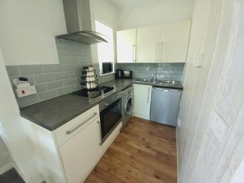 a kitchen with a sink and a stove top oven at Angel Lane Alnwick Apartment in Alnwick