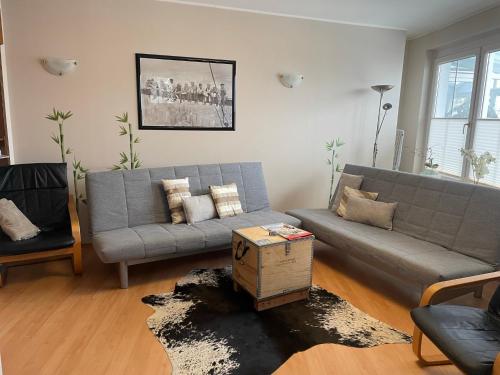 a living room with a couch and a table at Ferienwohnungen Panorama Harrys Bike Tours in Villach