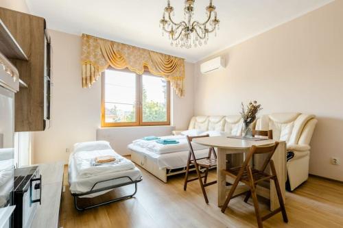 Deviza Apartments في بودابست: غرفة معيشة مع طاولة وغرفة طعام