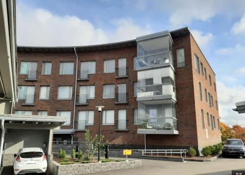 a brick building with a car parked in front of it at New&Easy apartment in the center in Turku