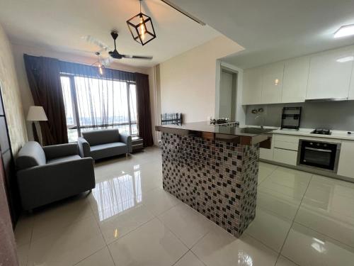 a kitchen and living room with a counter in a room at Paloma in Subang Jaya