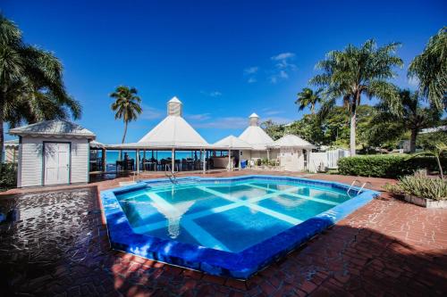 a swimming pool in a resort with a gazebo at Hawksbill Resort Antigua - All Inclusive in Five Islands Village