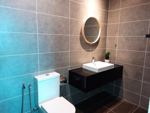 a bathroom with a toilet and a sink and a mirror at Onsen Suite at Sunway Lost World Tambun in Ipoh