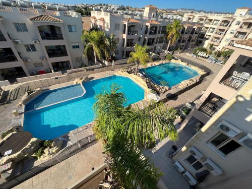 an overhead view of two swimming pools in a building at Royal Seacrest new apartment B G2 ground floor in Paphos