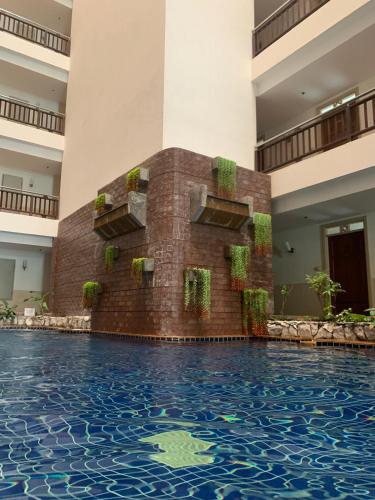 a swimming pool in the middle of a building at Supalai Oriental Place in Bangkok