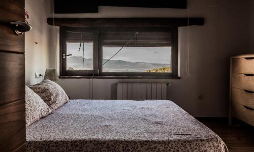 a bedroom with a bed in front of a window at Posada del Candil in Serón