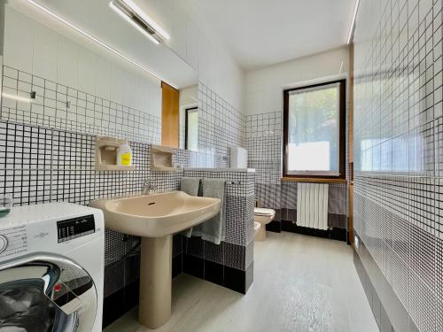 a white bathroom with a sink and a toilet at Eden sul Lago di Como in Nesso