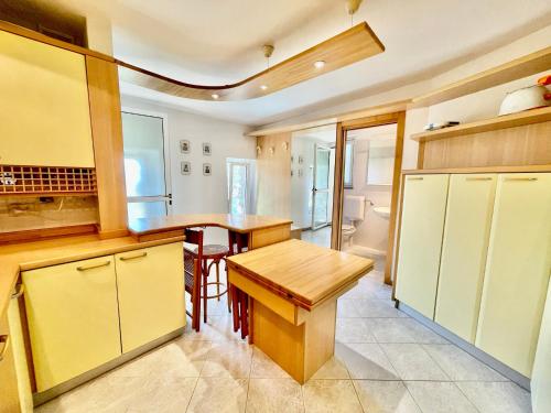 a kitchen with yellow cabinets and a wooden table at Eden sul Lago di Como in Nesso