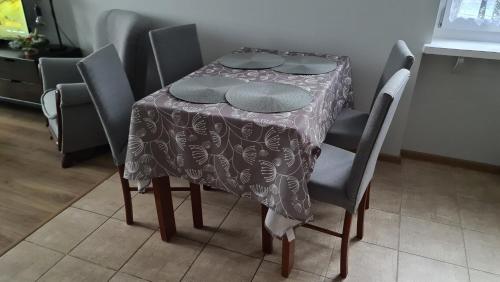 a table with a table cloth on top of it at Spokojny Wypoczynek 4 in Ostrów Wielkopolski