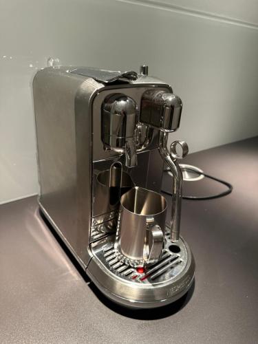 a coffee maker sitting on top of a table at Designer-Loft mit Whirlpool in Cologne