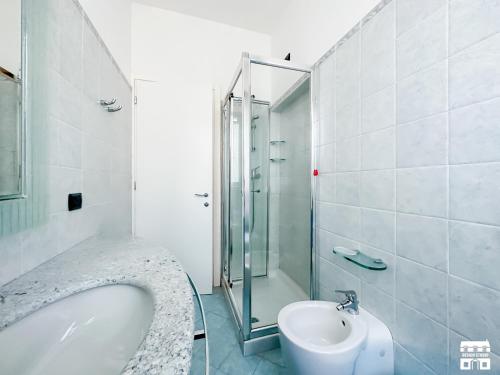a bathroom with a shower and a tub and a sink at AL LAGO by Design Studio in Bellano