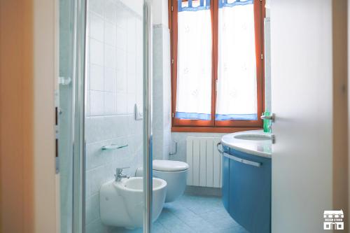 a bathroom with a toilet and a sink at AL LAGO by Design Studio in Bellano