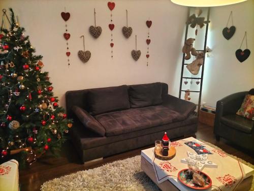 a living room with a christmas tree and a couch at "Coeur d'elsass"Colmar centre bel appartement avec parking privé in Colmar