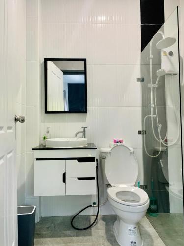 a bathroom with a toilet and a sink and a shower at Bonnie Baan Private Pool Villa, Mae Rim in Mae Rim