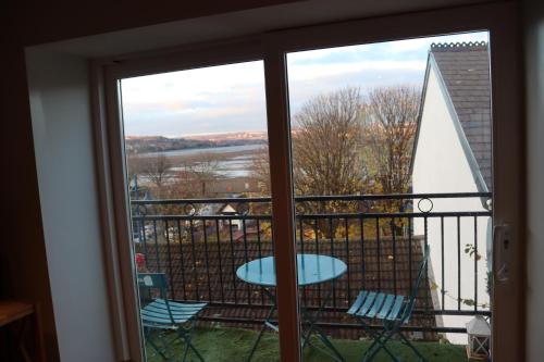 a view of a balcony with a table and chairs at Extended Fishermans cottage with stunning sea views in The Mumbles
