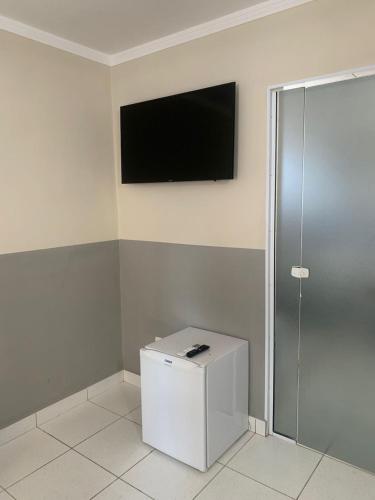 a room with a flat screen tv on the wall at Hotel Barão Ribeirão in Ribeirão Preto