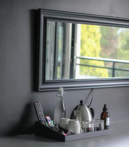 a shelf with a mirror and a tea kettle at The Raz in Harrismith