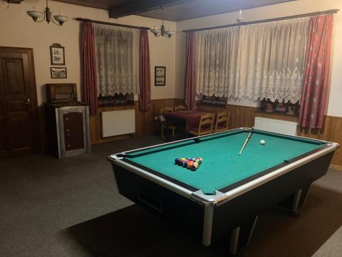 a pool table in a living room with afits at U potoka Cedronu in Jilemnice