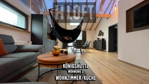 a living room with a hammock hanging from the ceiling at H-Loft Style Apartments in Bad Lauterberg