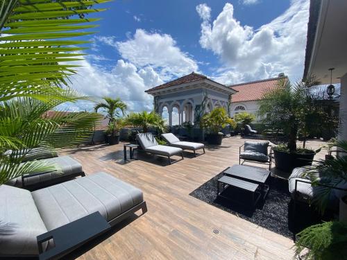 a patio with couches and chairs and a building at AmazINN Places Casco Viejo Pool and Rooftop V in Panama City