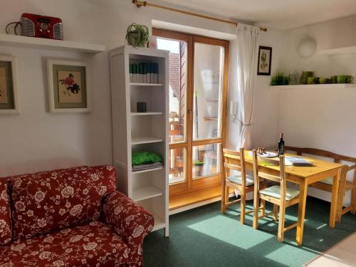 ein Wohnzimmer mit einem Tisch und einem Sofa sowie einem Tisch und Stühlen in der Unterkunft Apartmán 6 u sjezdovek in Rokytnice nad Jizerou