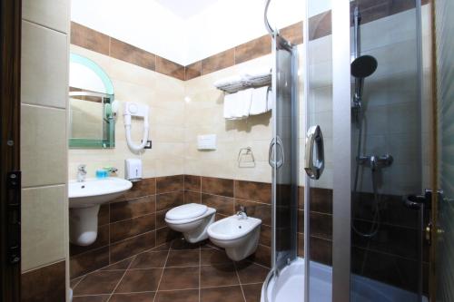 a bathroom with two toilets and a sink and a shower at Hotel PANORAMA Kruje view on the castle and the old town in Krujë