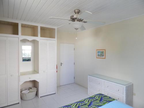 a bedroom with a bed and a ceiling fan at Heywoods Villa in Saint Peter