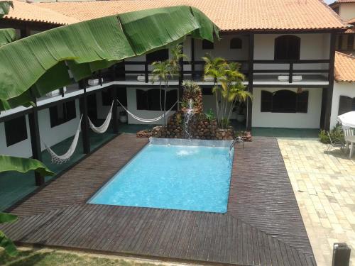 a swimming pool in front of a building at Pousada Solar de Itaúna in Saquarema