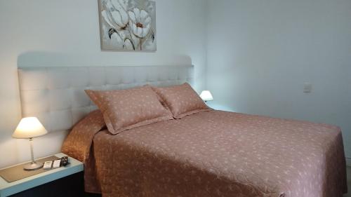 a bedroom with a bed and a table with a lamp at Green Park en Uruguay in Punta del Este