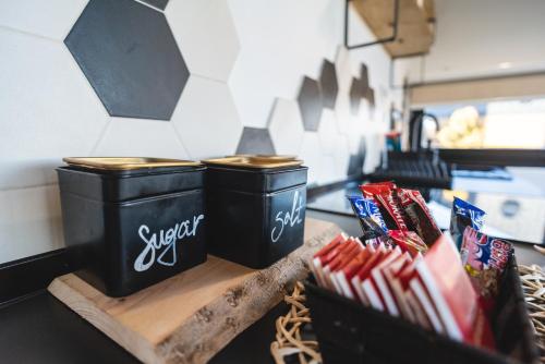 two black trash cans sitting on a counter with snacks at Wild nest Deer Lux in Zlatibor