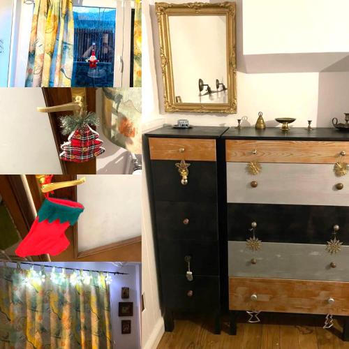 a bathroom with a black dresser and a mirror at Apartamentul Ursilor in Predeal