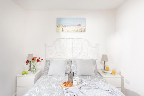 a bedroom with a white bed with a pumpkin on it at Wheal Amelia- Beautifully Fitted Wooden Lodge Helston Cornwall in Helston