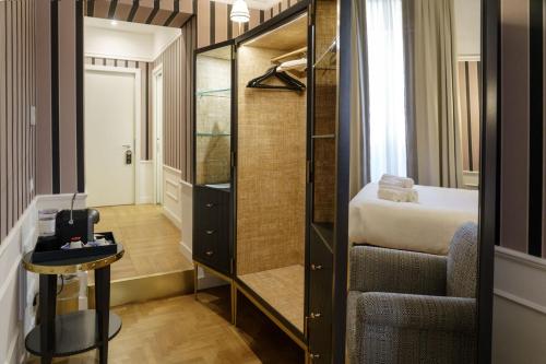 a small room with a bed and a stair case at Il Campo Marzio in Rome