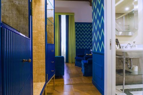 a bathroom with blue doors and a sink at Il Campo Marzio in Rome