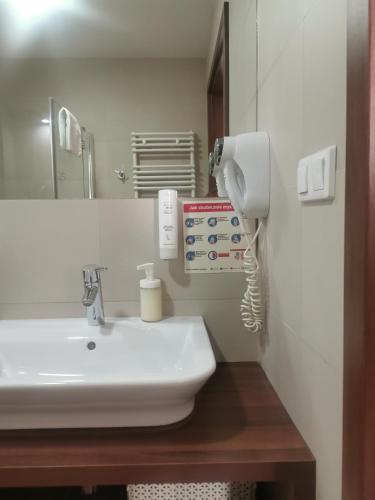 a bathroom with a sink and a phone at Apartament przy plaży in Międzyzdroje