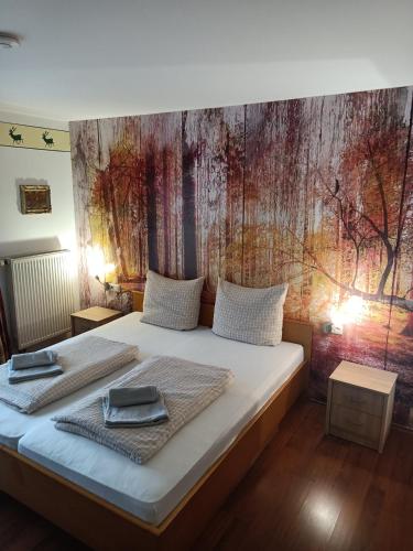 a bedroom with a bed with two towels on it at Wohnungen- Christopherhof MJ,Grafenwiesen in Grafenwiesen