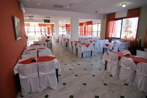 a room filled with tables and chairs with white table cloth at Morning Star in Kambos