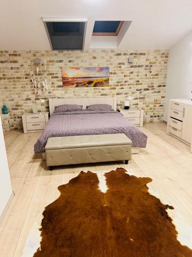 a bedroom with a bed in a brick wall at TOP PROPERTIES AND HOME in Voluntari