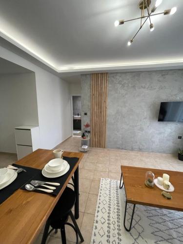 a living room with a table and a dining room at Evelyn's Apartment in Alexandroupoli
