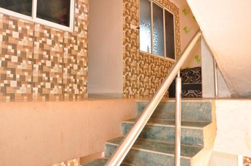 a staircase in a house with a brick wall at Relax inn in Matheran