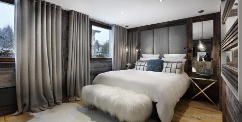 a bedroom with a large bed and a large window at Studio Megève centre in Megève
