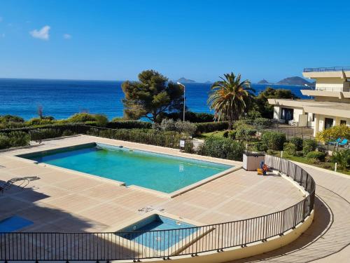 a swimming pool on a deck next to the ocean at CosySeaside Corsica Ajaccio Piscine Terrasse Mer in Ajaccio