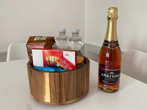 a bottle of champagne and a basket of alcohol at V&V CENTRE Neuchatel in Neuchâtel