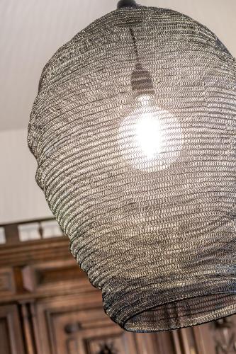 a large silver light fixture hanging from a ceiling at Roofs of the Old Tallinn Guest House in Tallinn