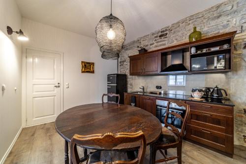 a kitchen with a wooden table and a dining room at Roofs of the Old Tallinn Guest House in Tallinn