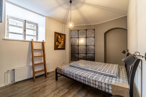 a bedroom with a bed and a ladder at Roofs of the Old Tallinn Guest House in Tallinn
