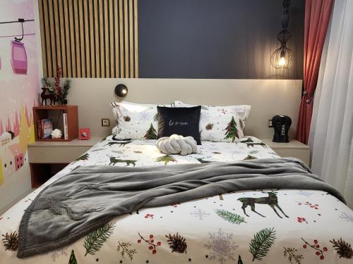 a bedroom with a bed with a blanket on it at Pinewood ANG luxurious apartment A43, Borovets Gardens in Borovets