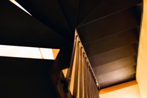 a spiral staircase in a building with a window at [Private Parking] centro storico: l'affresco in Bologna